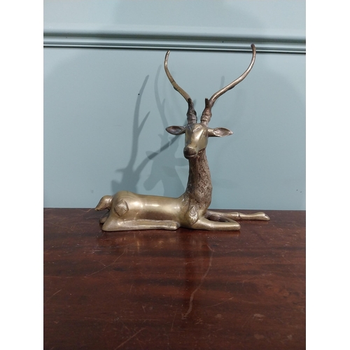 403 - Brass model of seated Stag. {30 cm H x 32 cm W x 13 cm D}.