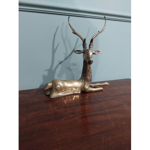 403 - Brass model of seated Stag. {30 cm H x 32 cm W x 13 cm D}.