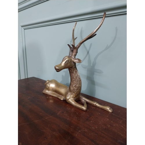 403 - Brass model of seated Stag. {30 cm H x 32 cm W x 13 cm D}.