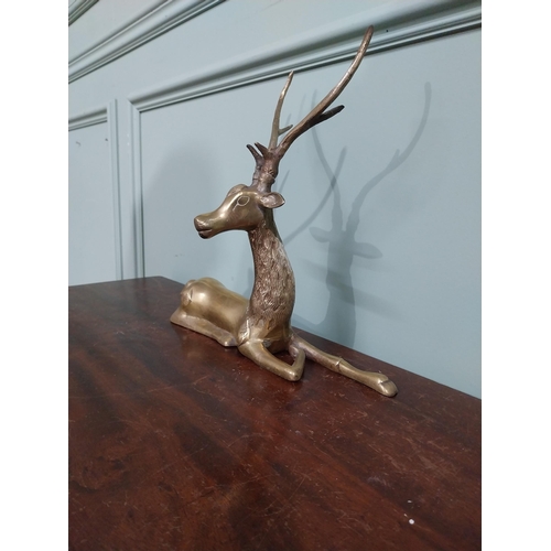 403 - Brass model of seated Stag. {30 cm H x 32 cm W x 13 cm D}.