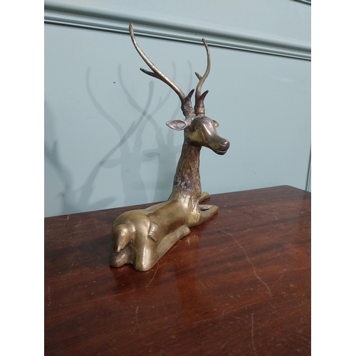 403 - Brass model of seated Stag. {30 cm H x 32 cm W x 13 cm D}.