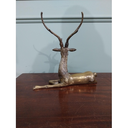 403 - Brass model of seated Stag. {30 cm H x 32 cm W x 13 cm D}.