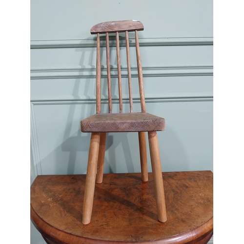 470 - Pine child's chair raised on four splayed feet with curved spindle back. {70 cm H x 25 cm W x 30 cm ... 