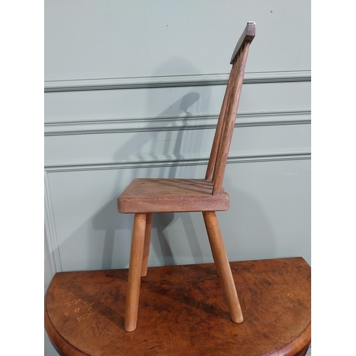 470 - Pine child's chair raised on four splayed feet with curved spindle back. {70 cm H x 25 cm W x 30 cm ... 