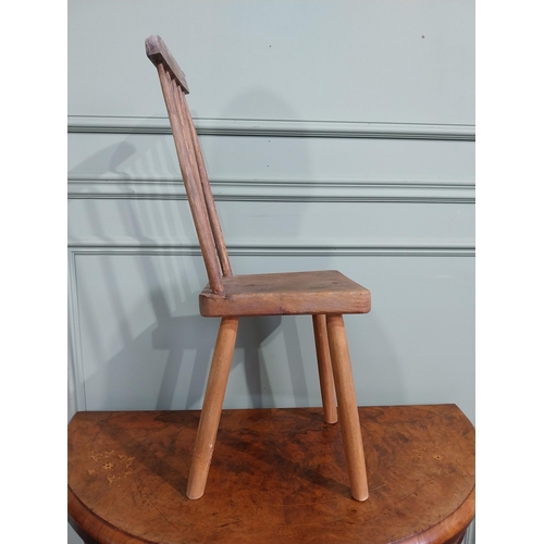 470 - Pine child's chair raised on four splayed feet with curved spindle back. {70 cm H x 25 cm W x 30 cm ... 