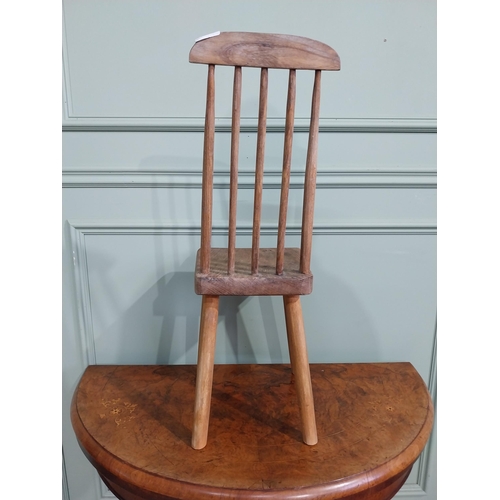 470 - Pine child's chair raised on four splayed feet with curved spindle back. {70 cm H x 25 cm W x 30 cm ... 