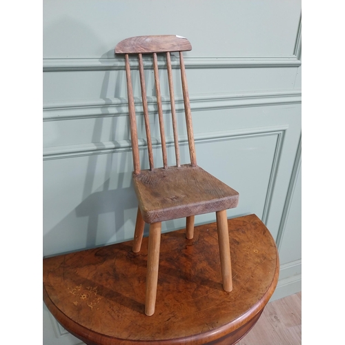 470 - Pine child's chair raised on four splayed feet with curved spindle back. {70 cm H x 25 cm W x 30 cm ... 