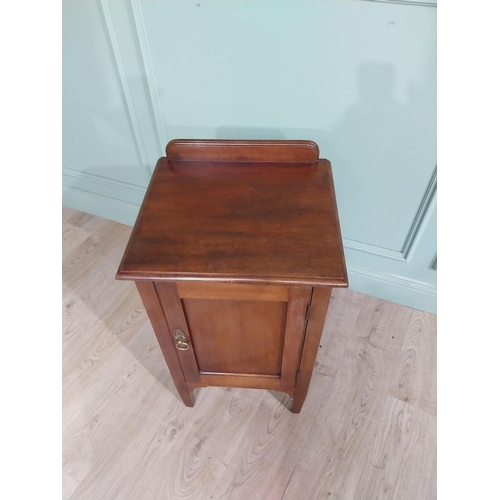 477 - Edwardian mahogany bedside locker with gallery back and single door raised on tapered legs. {82 cm H... 