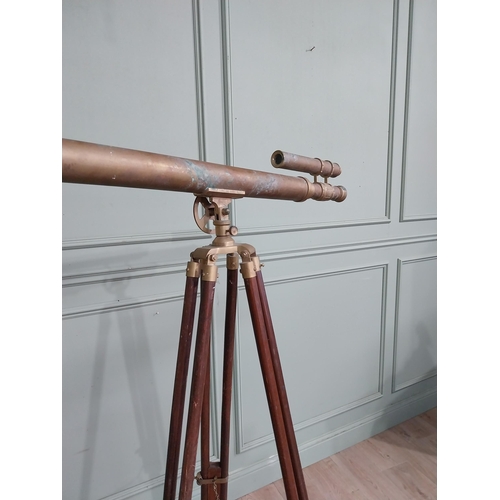 54 - Brass telescope on mahogany tripod stand. {165 cm H x 97 cm W x 55 cm D}.