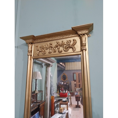 56 - Regency gilt wood pier wall mirror decorated with foliage and flanked by two shaped columns. {96 cm ... 