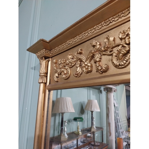 56 - Regency gilt wood pier wall mirror decorated with foliage and flanked by two shaped columns. {96 cm ... 