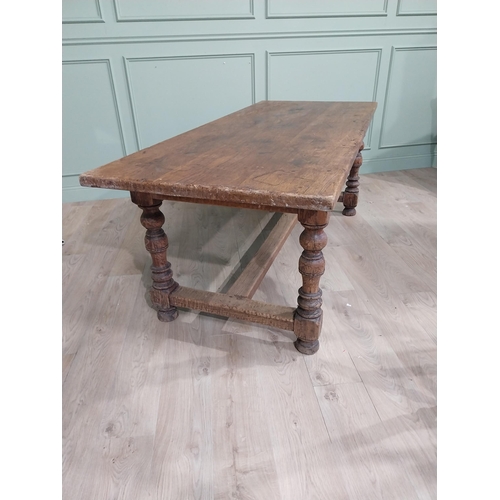 58 - 19th C. Oak kitchen table on turned legs with single stretcher. {76 cm H x 200 cm W x 85 cm D}.