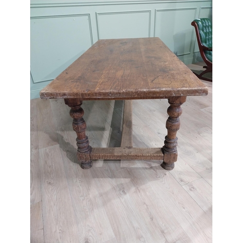 58 - 19th C. Oak kitchen table on turned legs with single stretcher. {76 cm H x 200 cm W x 85 cm D}.