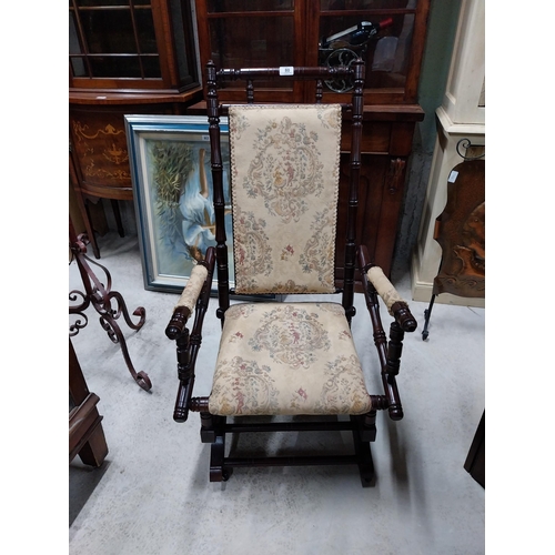 80 - Mahogany and upholstered Rocking chair in the Victorian style. {100 cm H x 54 cm W x 65 cm D}.