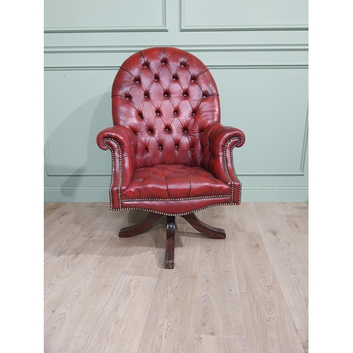 90 - Good quality hand dyed French oxblood leather deep buttoned swivel office chair raised on four splay... 