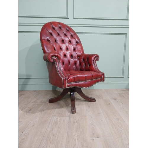 90 - Good quality hand dyed French oxblood leather deep buttoned swivel office chair raised on four splay... 