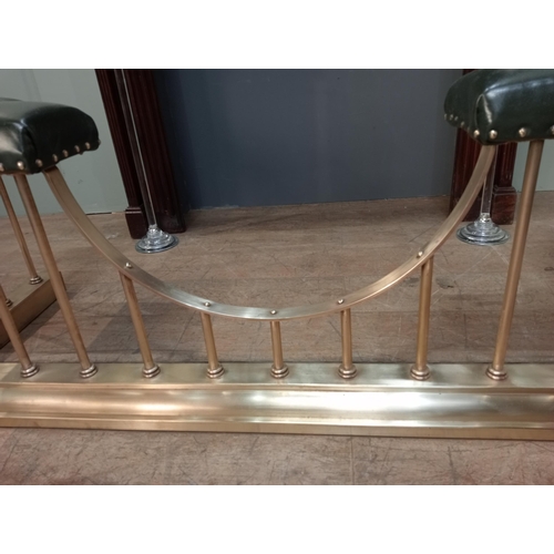 12 - Brass and green leather upholstered club fender with brass studs. {H 50cm x W 154cm x D 55cm Inside ... 