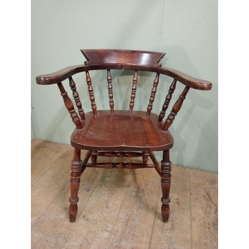 126 - Oak Smokers Bow armchair with curved shaped arms raised on splayed turned feet. {H 89cm x W 60cm x D... 