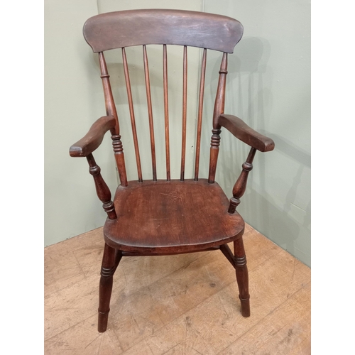 287 - Oak spindleback armchair raised on splayed feet. {H 103cm x W 56cm x D 66cm }