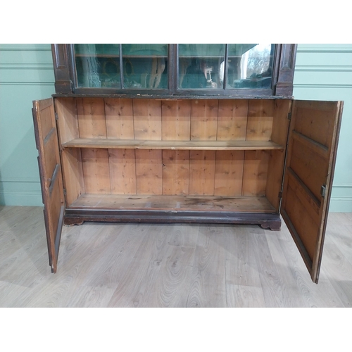 319 - Early 20th C. Original scumbled pine bookcase with two long glazed doors flanked by inset columns ov... 