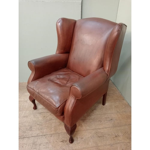 73 - Laura Ashley leather upholstered wingback armchair raised on cabriole legs.  {H 104cm x  W 80cm x D ... 