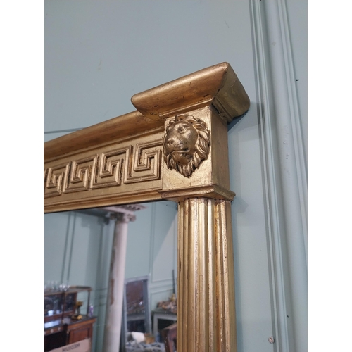 112 - Regency gilt wall mirror flanked by lion�s masks and Grecian key pattern. {64 cm H x 101 cm W}.