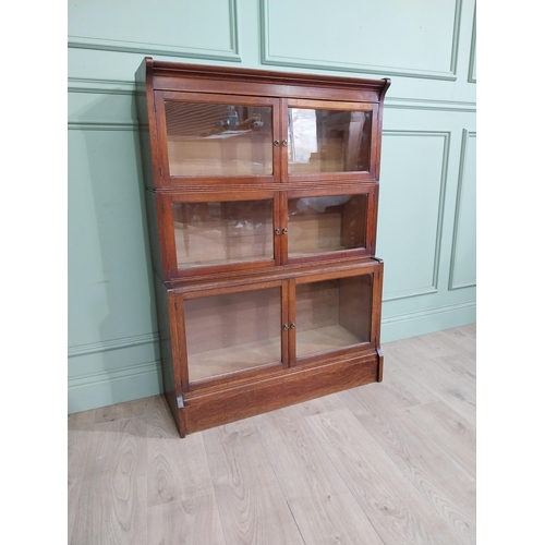 131 - 1940�s oak waterfall Globe Wernicke style glazed cabinet. {122 cm H x 88 cm W x 32 cm D}.