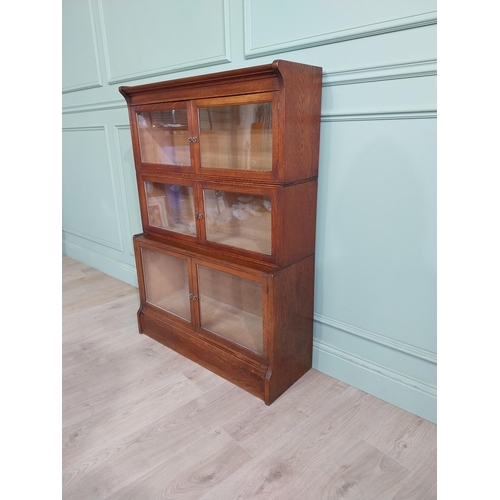 131 - 1940�s oak waterfall Globe Wernicke style glazed cabinet. {122 cm H x 88 cm W x 32 cm D}.