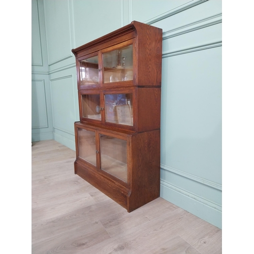 131 - 1940�s oak waterfall Globe Wernicke style glazed cabinet. {122 cm H x 88 cm W x 32 cm D}.