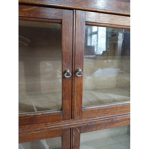 131 - 1940�s oak waterfall Globe Wernicke style glazed cabinet. {122 cm H x 88 cm W x 32 cm D}.