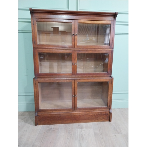 131 - 1940�s oak waterfall Globe Wernicke style glazed cabinet. {122 cm H x 88 cm W x 32 cm D}.