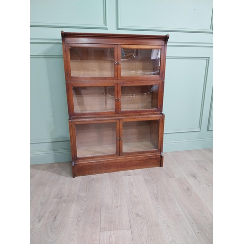 131 - 1940�s oak waterfall Globe Wernicke style glazed cabinet. {122 cm H x 88 cm W x 32 cm D}.