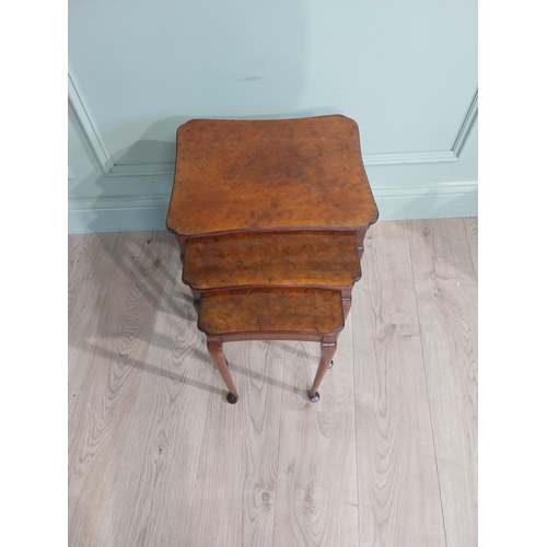 141 - Edwardian burr walnut nest of three tables raised on cabriole legs. {48 cm H x 40 cm W x 33 cm D}.