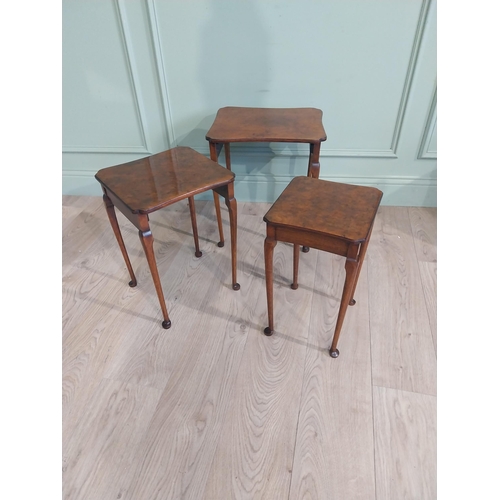 141 - Edwardian burr walnut nest of three tables raised on cabriole legs. {48 cm H x 40 cm W x 33 cm D}.