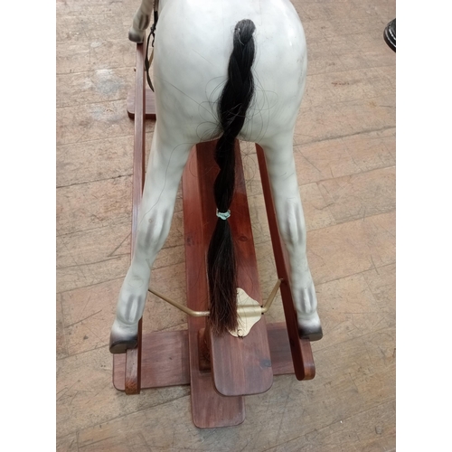 143 - Painted dapple grey rocking horse with leather reins and saddle.  {H 115cm x W 130cm x D 46cm}. NOT ... 