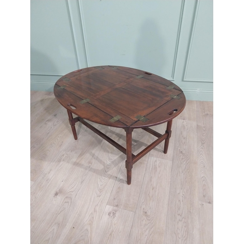 244 - 19th C. Mahogany oval campaign coffee table with double stretcher raised on tapered legs. {68 cm H x... 