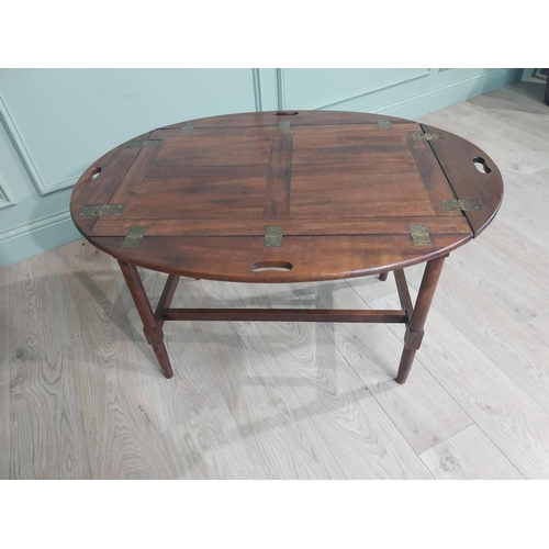 244 - 19th C. Mahogany oval campaign coffee table with double stretcher raised on tapered legs. {68 cm H x... 