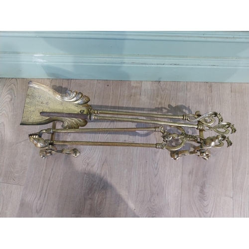 245 - Edwardian brass fire irons and dogs. {23 cm H x 73 cm W x 17 cm D}