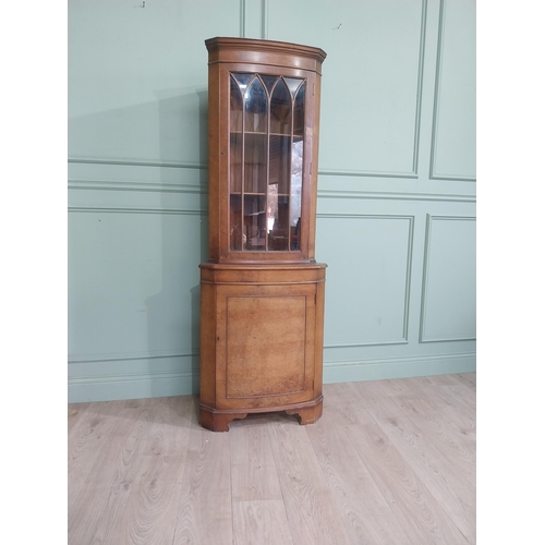 278 - Walnut corner cabinet with glazed door over single door. {182 cm H x 65 cm W x 42 cm D}.