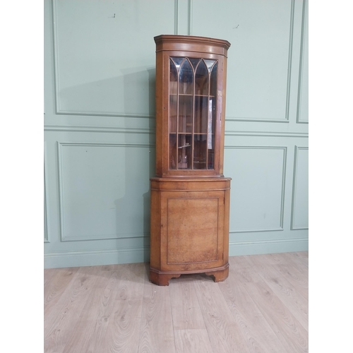 278 - Walnut corner cabinet with glazed door over single door. {182 cm H x 65 cm W x 42 cm D}.