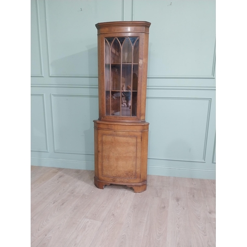 278 - Walnut corner cabinet with glazed door over single door. {182 cm H x 65 cm W x 42 cm D}.