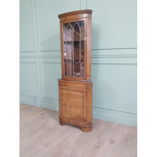 278 - Walnut corner cabinet with glazed door over single door. {182 cm H x 65 cm W x 42 cm D}.