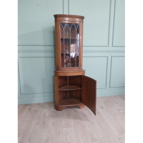 278 - Walnut corner cabinet with glazed door over single door. {182 cm H x 65 cm W x 42 cm D}.