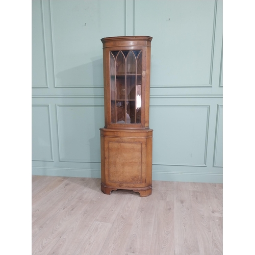 278 - Walnut corner cabinet with glazed door over single door. {182 cm H x 65 cm W x 42 cm D}.