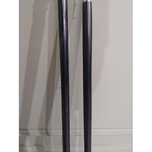 279 - Two silver plate and ebonised walking sticks. {95 cm H} and {90 cm H}.