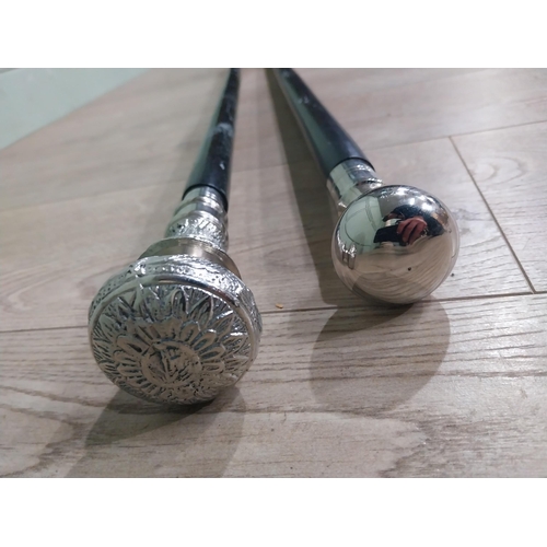 279 - Two silver plate and ebonised walking sticks. {95 cm H} and {90 cm H}.