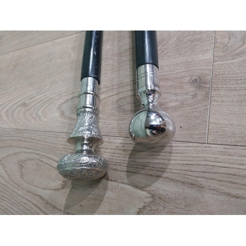 279 - Two silver plate and ebonised walking sticks. {95 cm H} and {90 cm H}.