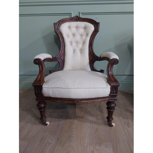 283 - Victorian carved mahogany and leather upholstered His and Her chairs on turned legs and castors. {10... 