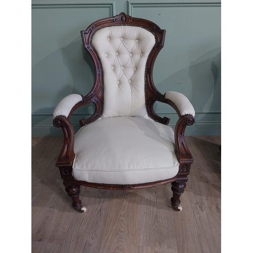 283 - Victorian carved mahogany and leather upholstered His and Her chairs on turned legs and castors. {10... 