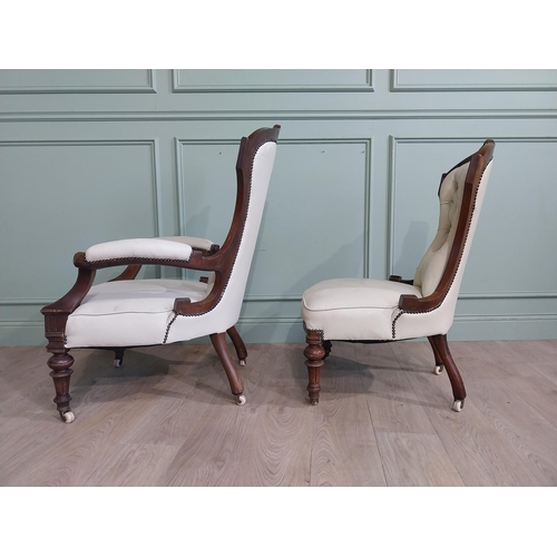 283 - Victorian carved mahogany and leather upholstered His and Her chairs on turned legs and castors. {10... 